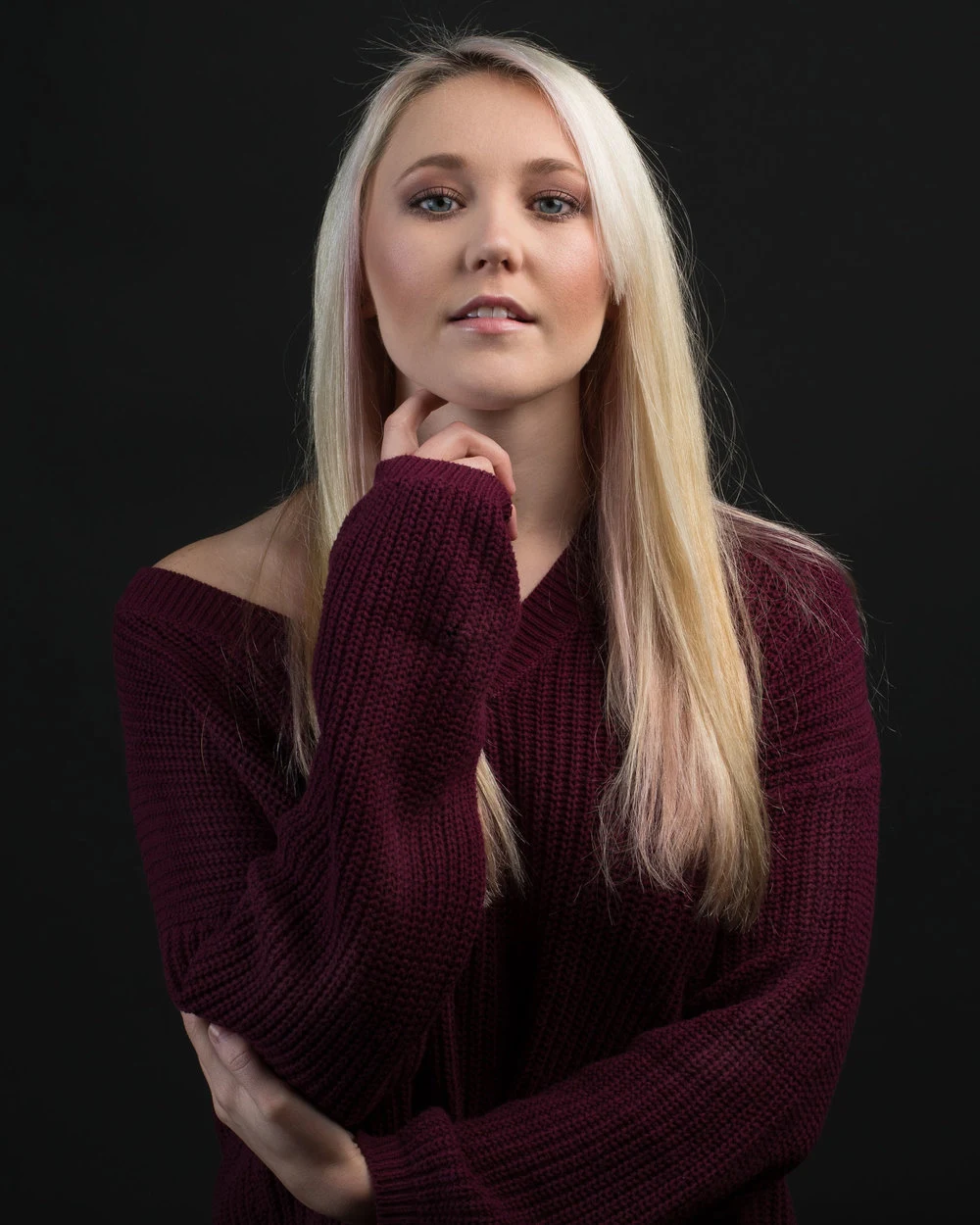 Studio portrait of a woman in a burgundy top