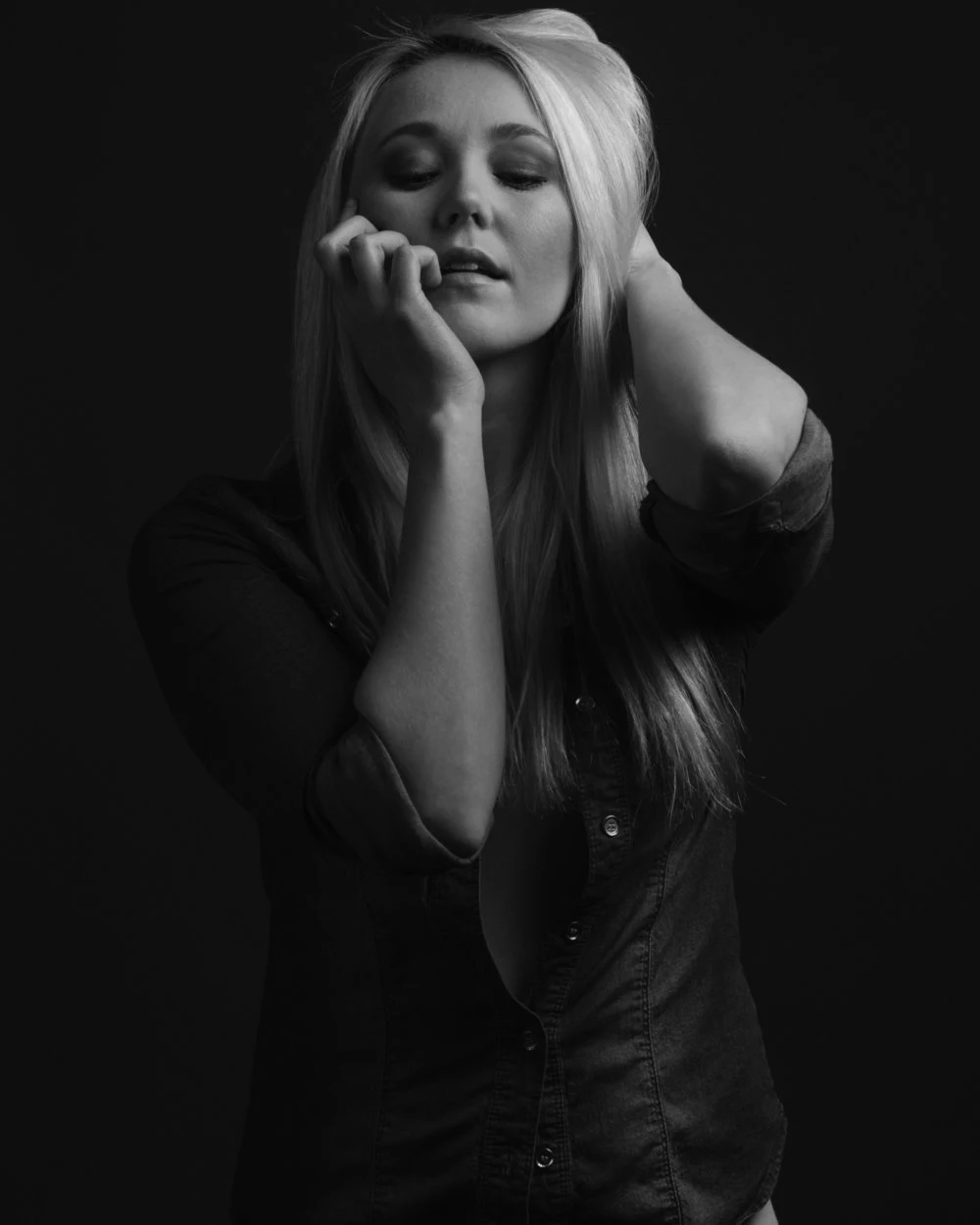 Black and white portrait of a woman resting her chin on her hand