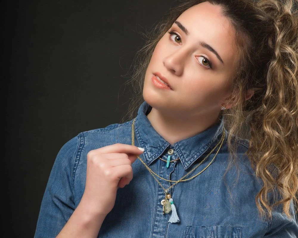 Close portrait of a woman in a denim shirt