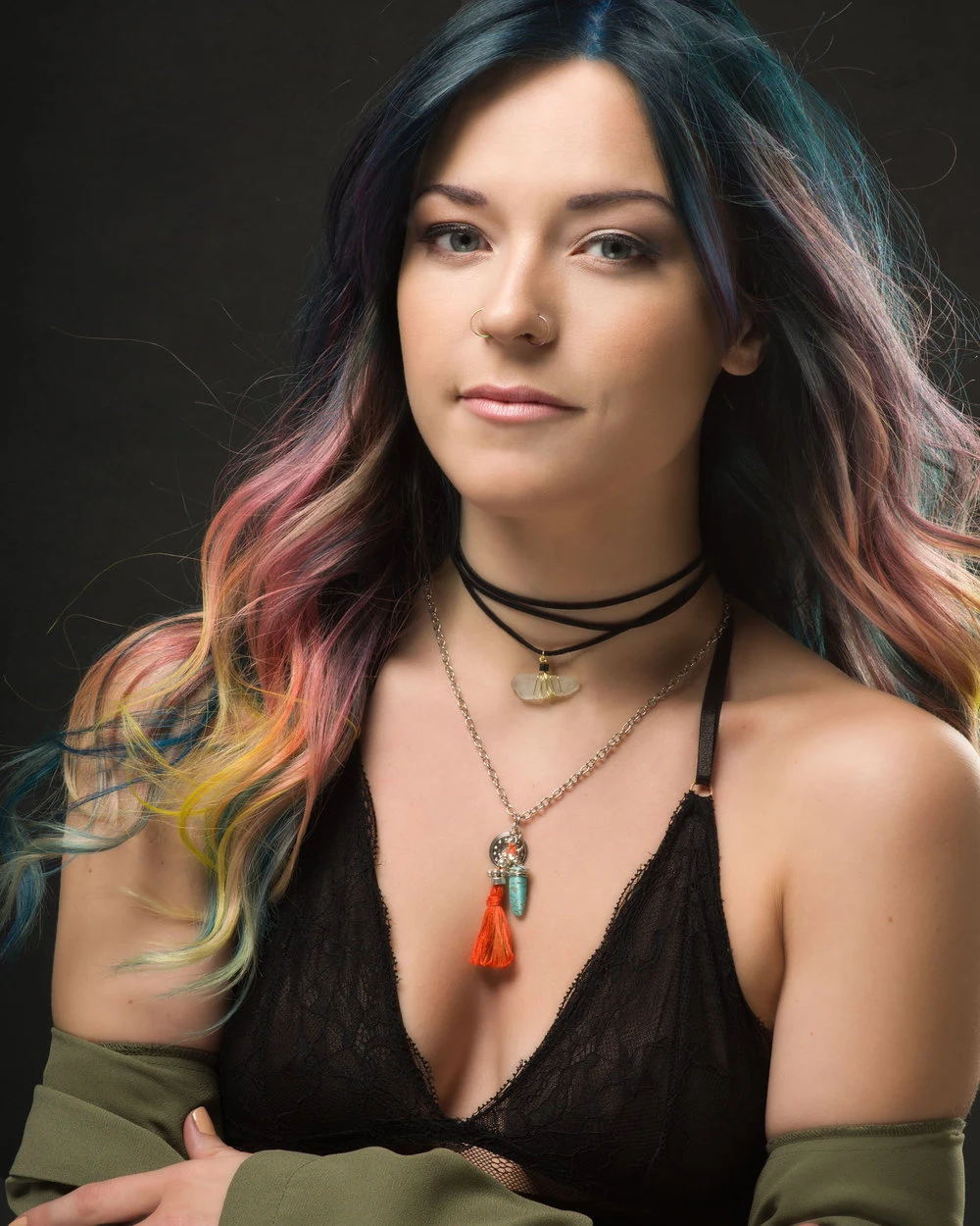 Studio portrait with colourful hair and layered jewellery