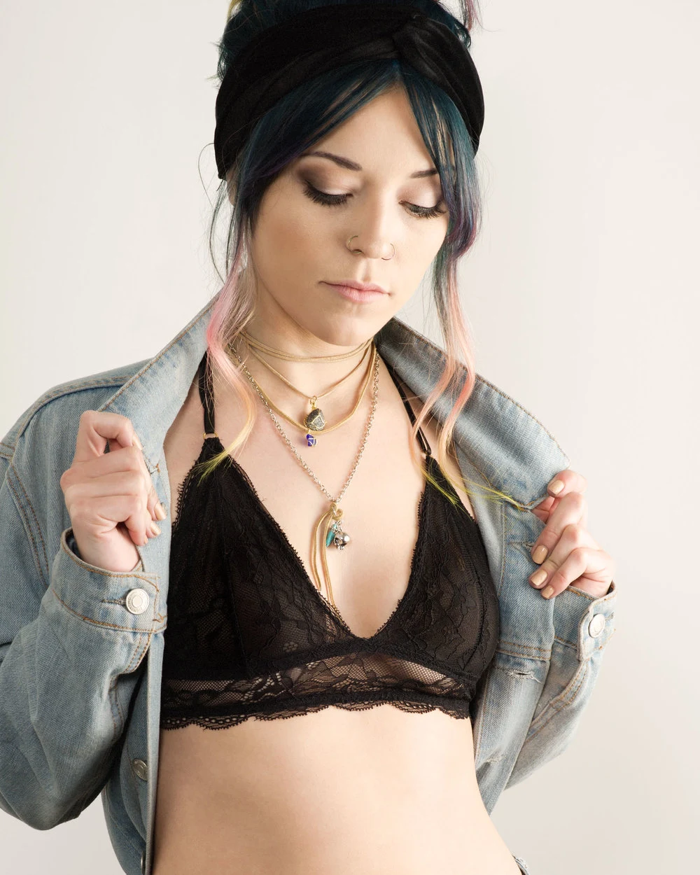 Fashion portrait with a denim jacket and layered necklaces