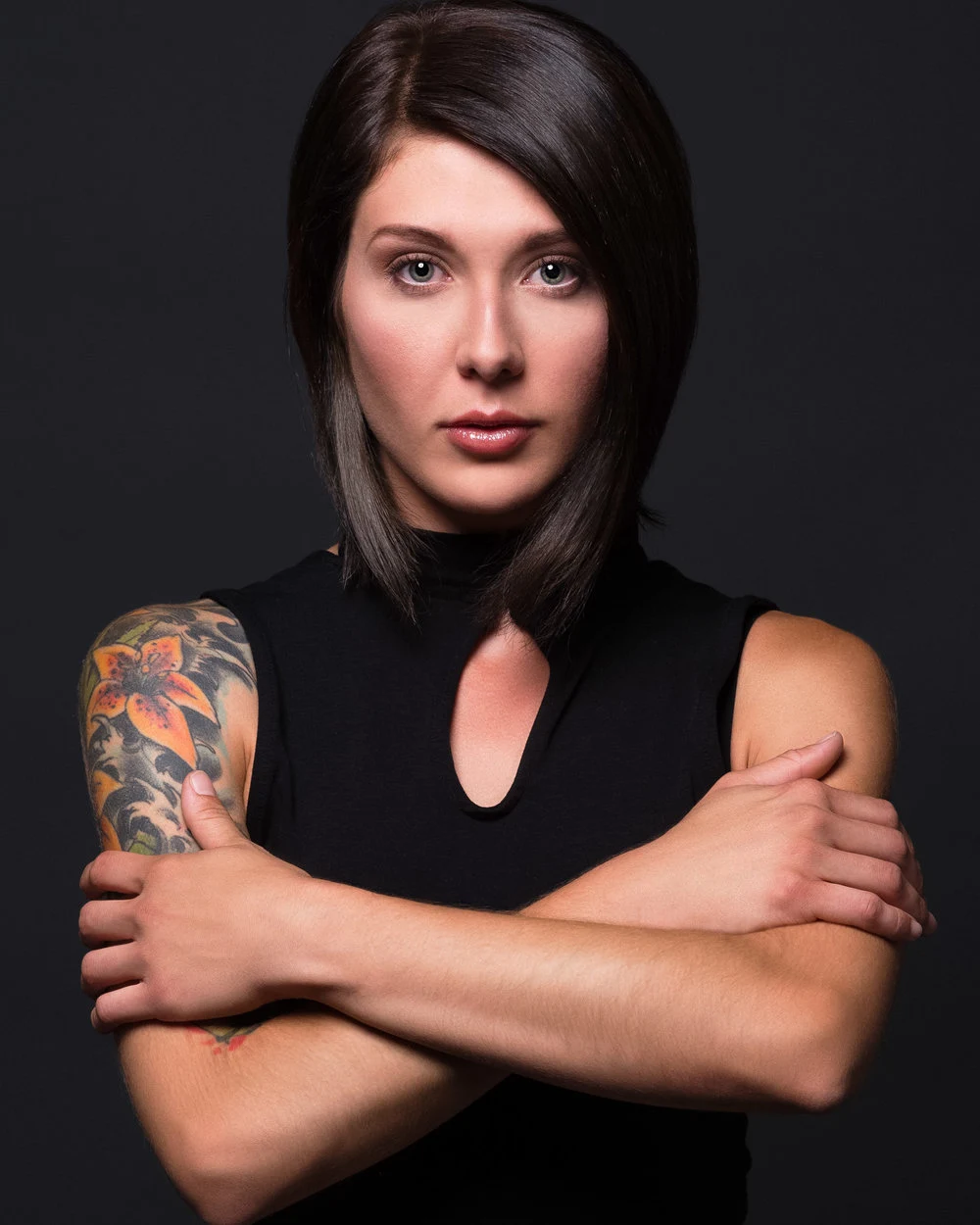 Portrait of a tattooed woman with folded arms