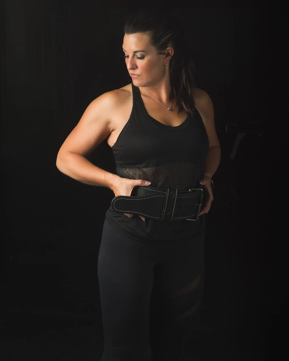 Studio portrait of a woman in black athletic clothing