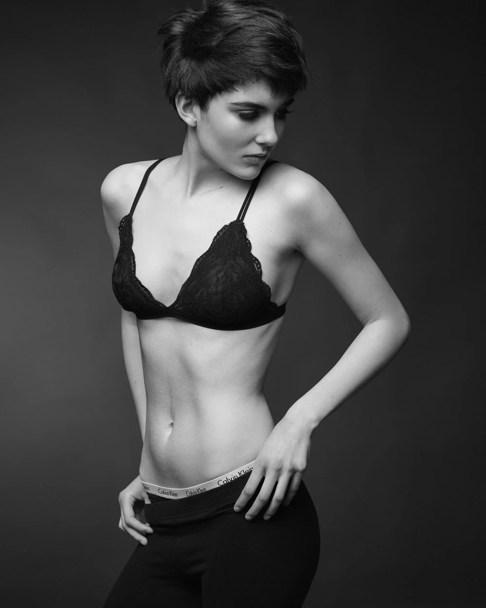 Black and white studio portrait in a black bralette