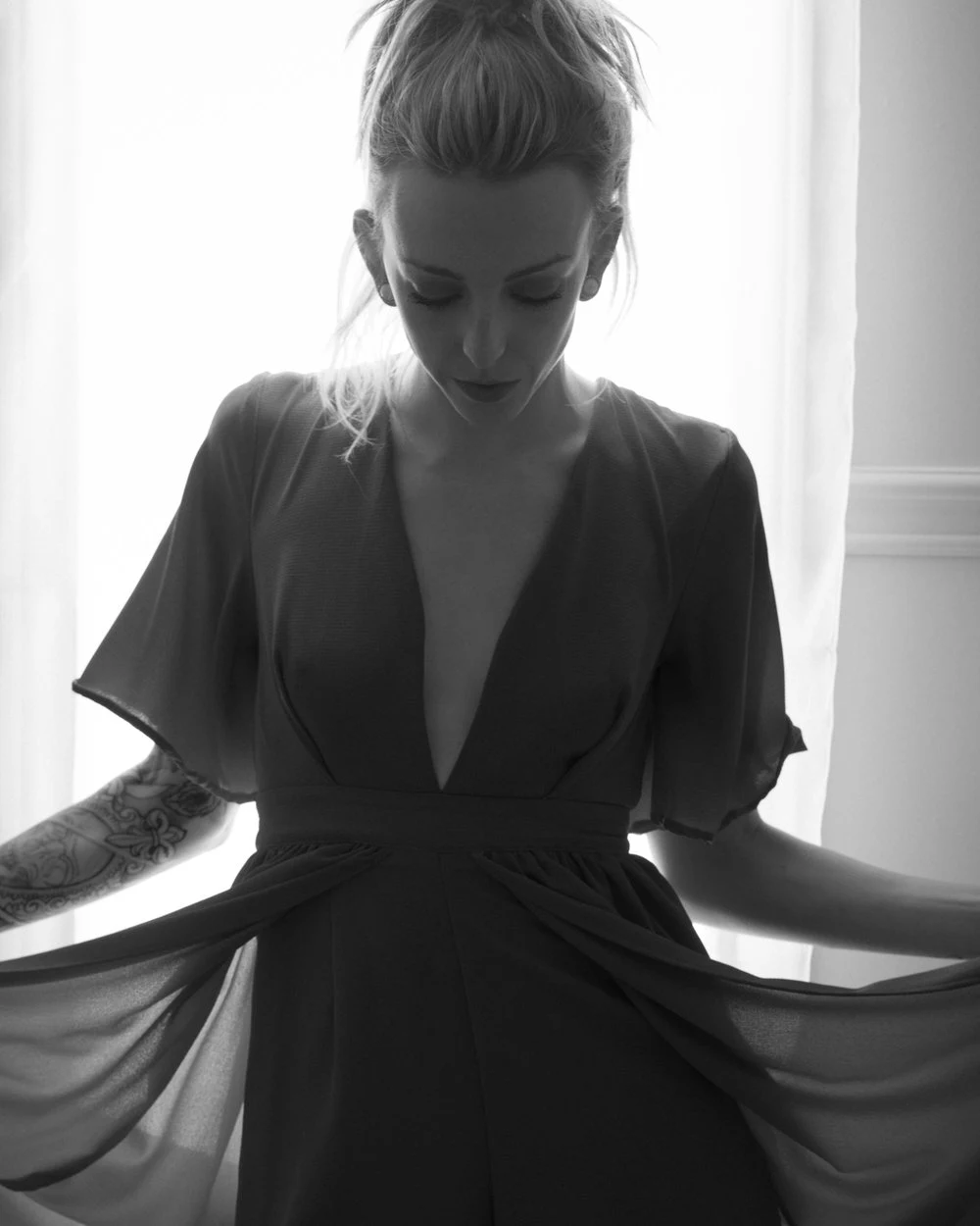 Black and white portrait beside a bright window