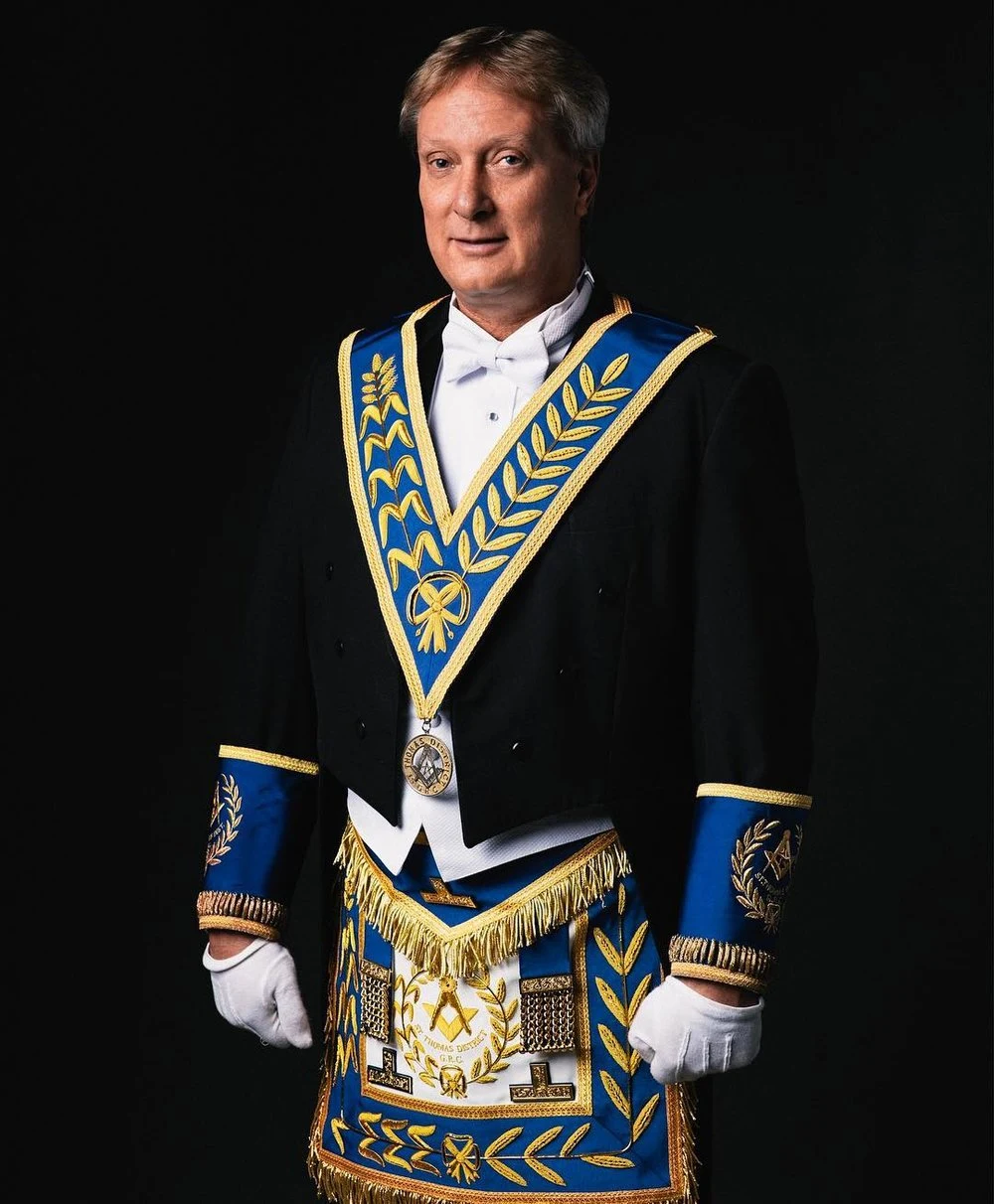 Formal portrait with a blue and gold ceremonial collar
