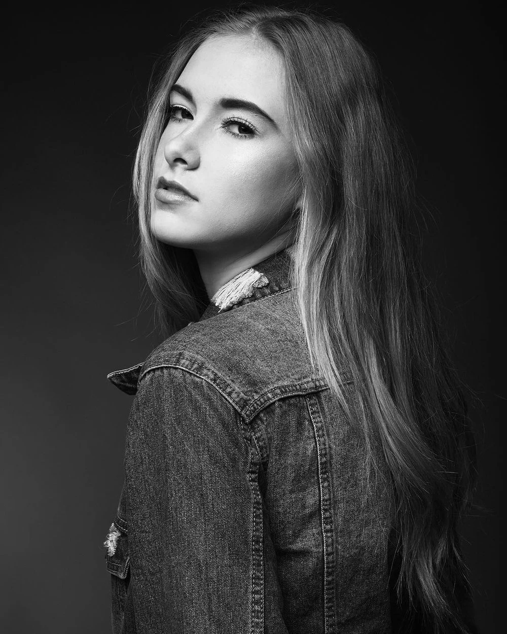 Black and white portrait looking back over one shoulder
