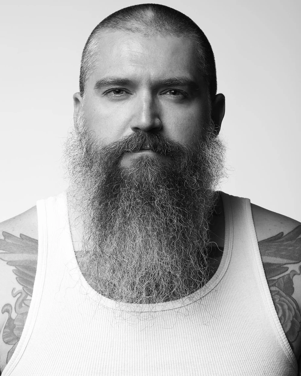 Black and white headshot of a man with a long beard