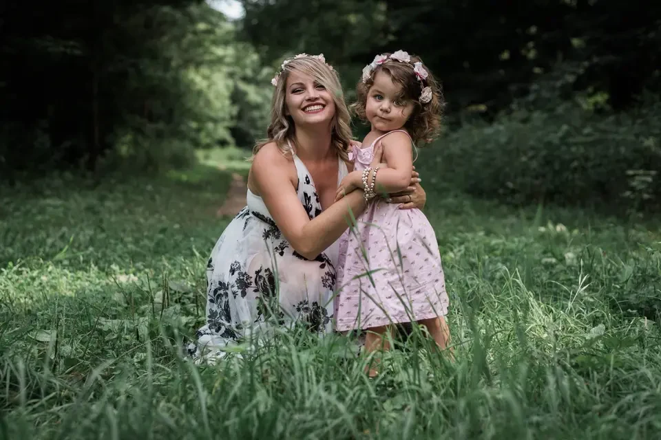 Mother and daughter together in a green meadow