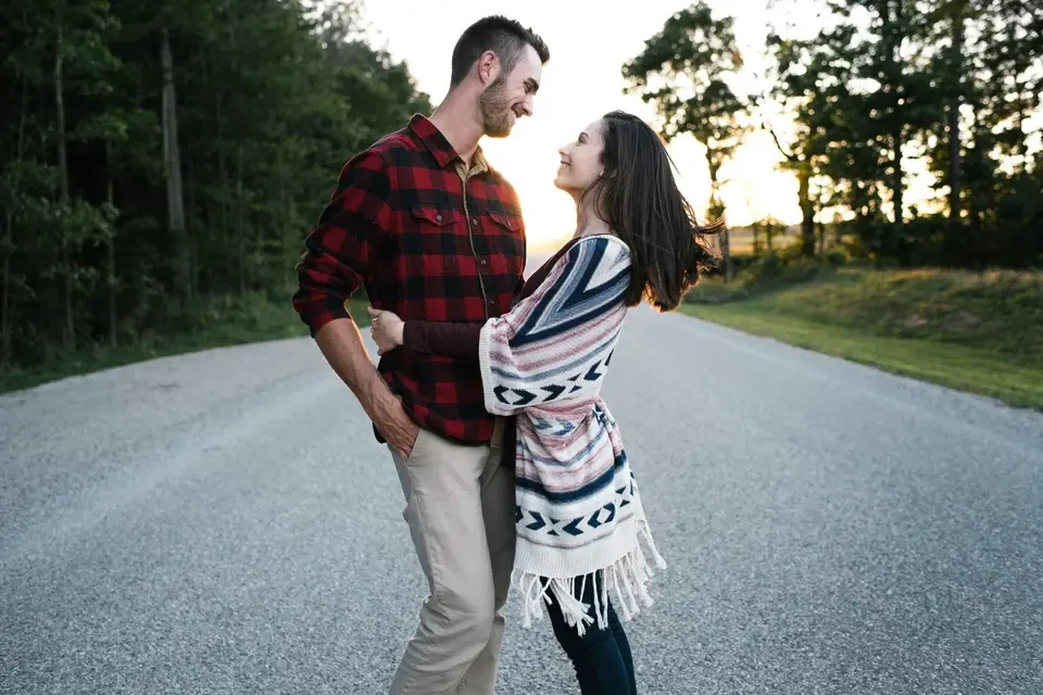 Engaged couple standing together on a quiet road