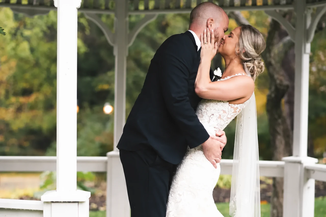 Wedding couple kissing outdoors