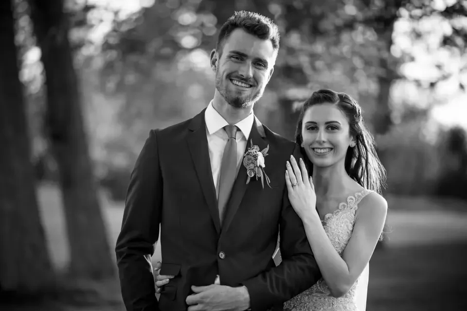 Black and white wedding portrait of a smiling couple