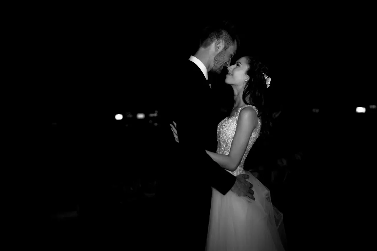 Wedding couple dancing against a dark background
